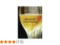 Couverture du livre "Secrets de CHAMPAGNE" de Sylvie Schindler, avec un verre de champagne pétillant. Le livre explore les secrets de ce cépage champenois.