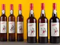 Six bouteilles de madère alcool Barbeito, avec des étiquettes illustrant des scènes traditionnelles de l'île.
