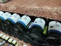 Bouteilles de cépage Pinot Gris d'Alsace, étiquetées "Famille Ancel", rangées sur une étagère en briques.