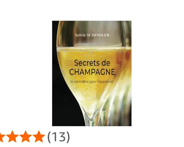 Couverture du livre "Secrets de CHAMPAGNE" de Sylvie Schindler, avec un verre de champagne pétillant. Le livre explore les secrets de ce cépage champenois.