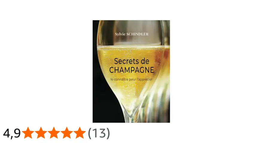 Couverture du livre "Secrets de CHAMPAGNE" de Sylvie Schindler, avec un verre de champagne pétillant. Le livre explore les secrets de ce cépage champenois.